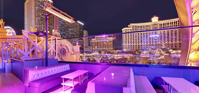 View from Chateau Nightclub; VIP tables and seating located in the foreground; part of Paris Hotel and Bellagio in background with other Las Vegas hotels in city line