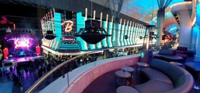 View of Troy Liquors Rooftop bar with VIP seating and tables on the bottom right; Binions in the background