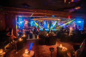 VIP area at Spearmint Rhino in Las Vegas with plush seating and performer on center stage