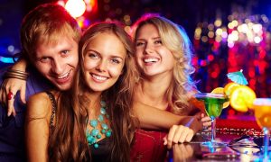 group of three smiling in miami bar
