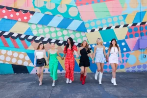 Bride tribe posing in front of Nashville mural