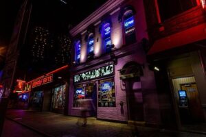 Haunted Tootsie's Orchid Lounge Nashville at night with glowing purple neon lights